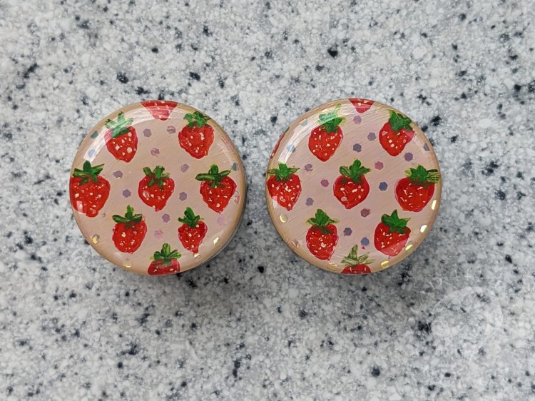 Silver ear plugs with handpainted red strawberries on dusty pink plugs fruit gauges