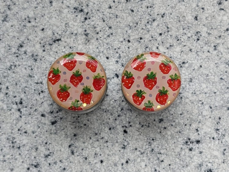 Silver ear plugs with handpainted red strawberries on dusty pink plugs fruit gauges