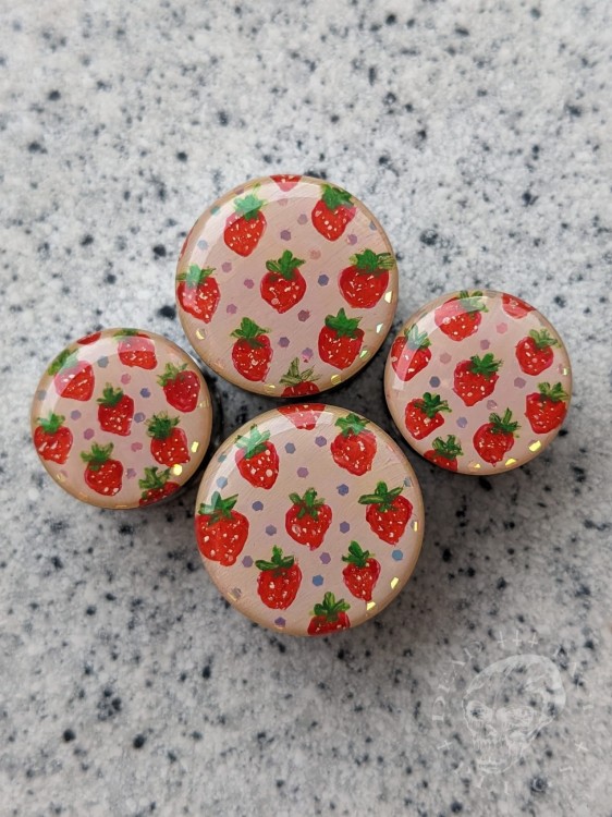 Silver ear plugs with handpainted red strawberries on dusty pink plugs fruit gauges