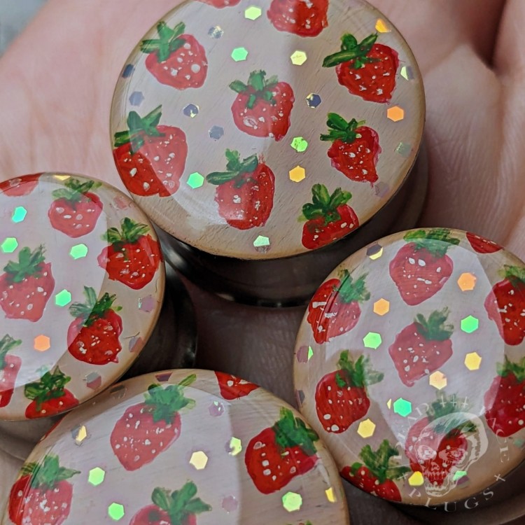 Silver ear plugs with handpainted red strawberries on dusty pink plugs fruit gauges