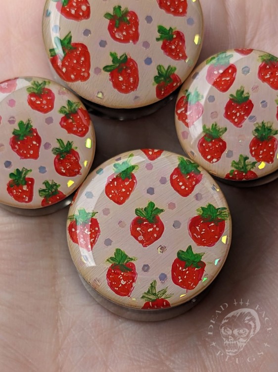 Silver ear plugs with handpainted red strawberries on dusty pink plugs fruit gauges