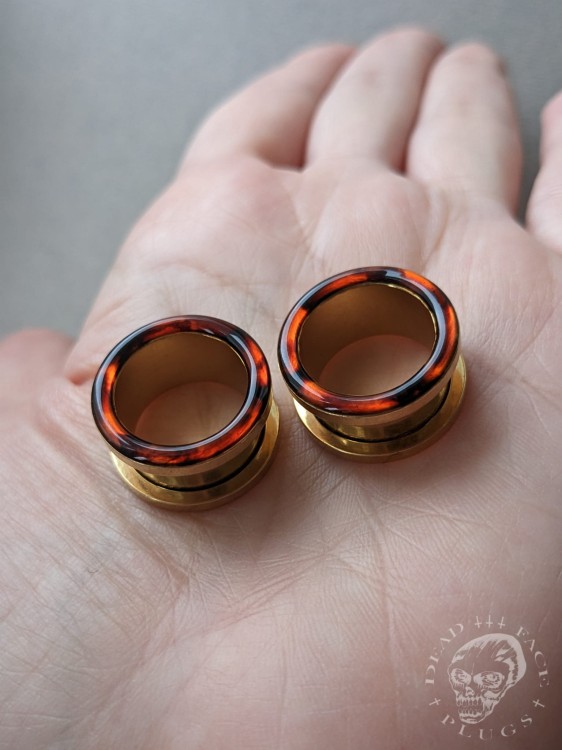 Gold screw-on ear plugs with orange and dark brown tortoiseshell resin