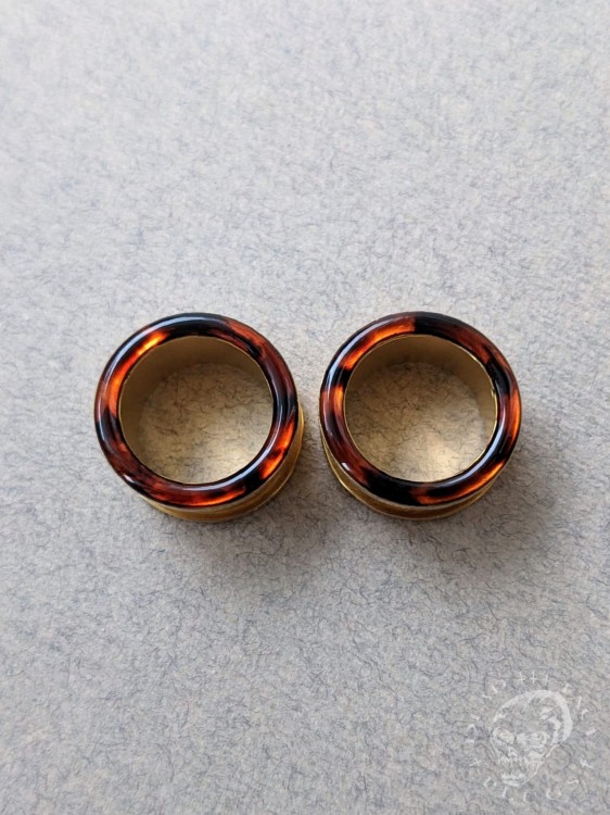Gold screw-on ear plugs with orange and dark brown tortoiseshell resin