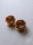 Gold screw-on ear plugs with orange and dark brown tortoiseshell resin