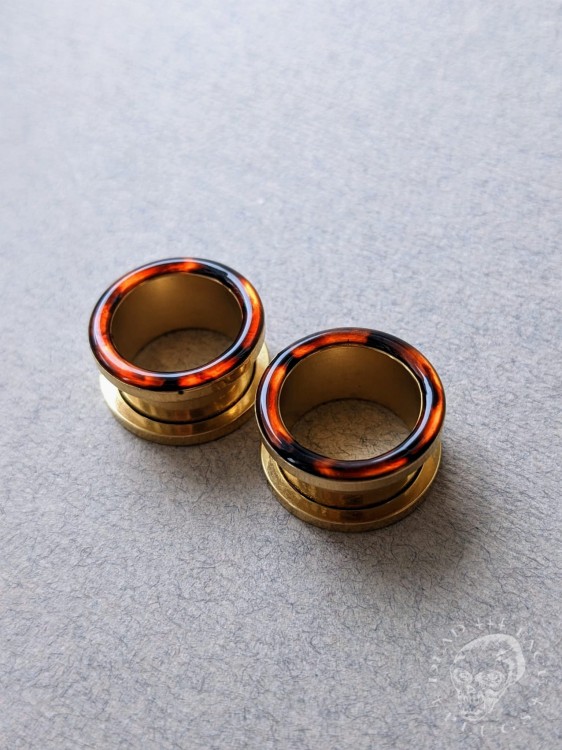 Gold screw-on ear plugs with orange and dark brown tortoiseshell resin