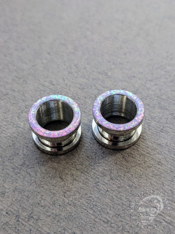 Magically opalescent ear plugs in surgical steel with lilac sparkles in pink, mint, gold, and green opalescent glitter