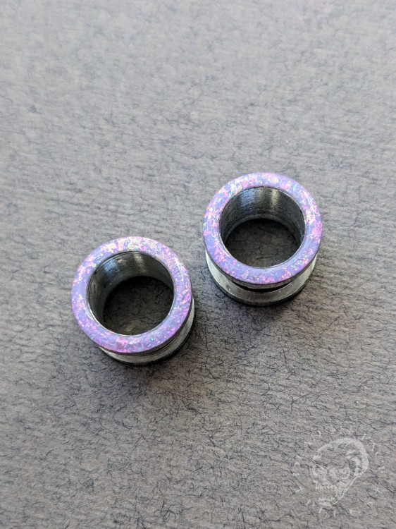 Magically opalescent ear plugs in surgical steel with lilac sparkles in pink, mint, gold, and green opalescent glitter