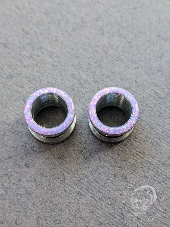 Magically opalescent ear plugs in surgical steel with lilac sparkles in pink, mint, gold, and green opalescent glitter