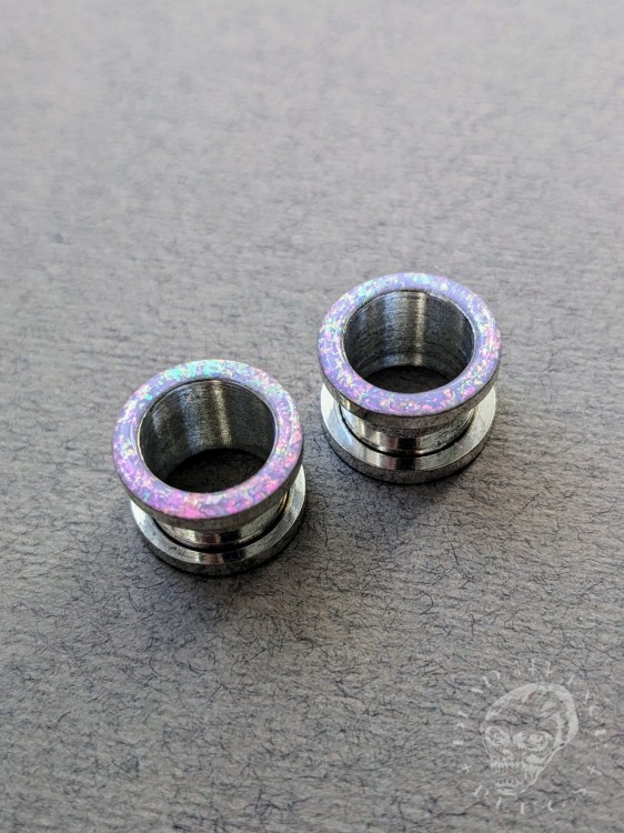 Magically opalescent ear plugs in surgical steel with lilac sparkles in pink, mint, gold, and green opalescent glitter