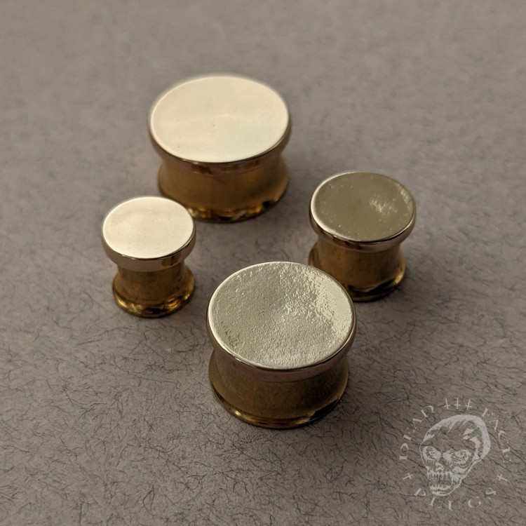 Unique ear plugs with gold stainless steel tunnels and mirror-finish bronze discs.