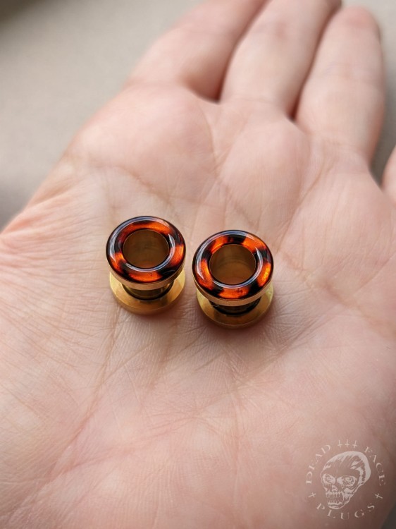 Handmade surgical steel ear plugs with brown and orange tortoiseshell resin