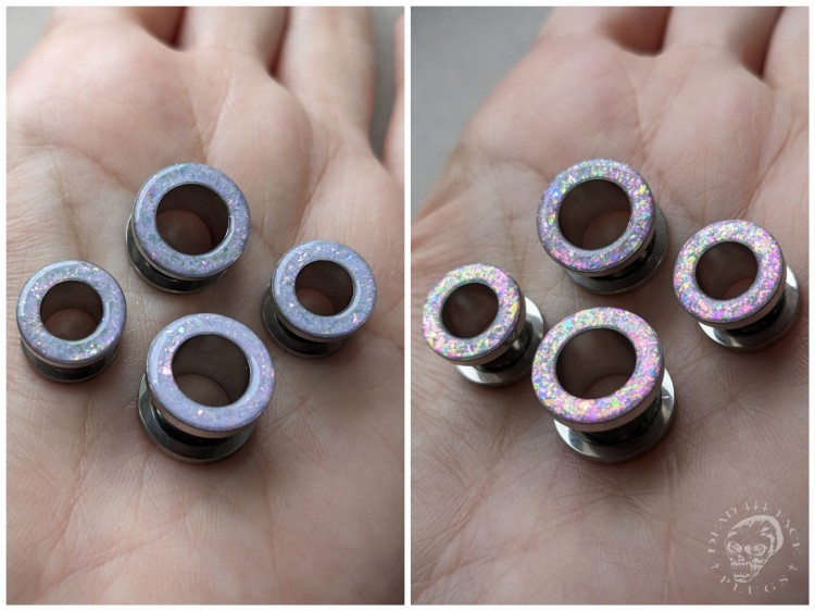 Magically opalescent ear plugs in surgical steel with lilac sparkles in pink, mint, gold, and green opalescent glitter