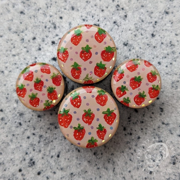 Silver ear plugs with handpainted red strawberries on dusty pink plugs fruit gauges