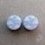 Silver ear plugs with blue and lilac violet purple ombre effect, decorated with fluffy white clouds.