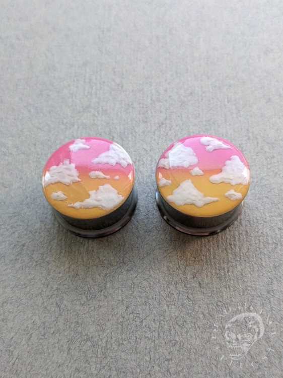 Stylish silver ear tunnels with colorful ombre design and cloud decoration.