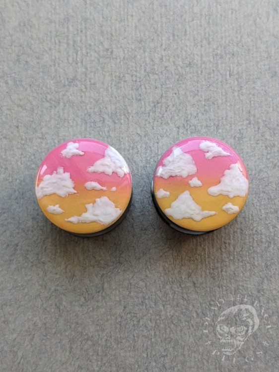 Stylish silver ear tunnels with colorful ombre design and cloud decoration.