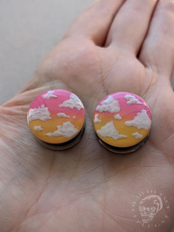 Stylish silver ear tunnels with colorful ombre design and cloud decoration.