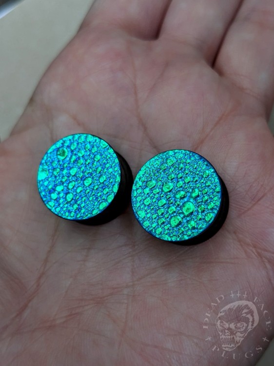 Unique black steel ear plugs with colorful surface and textured finish