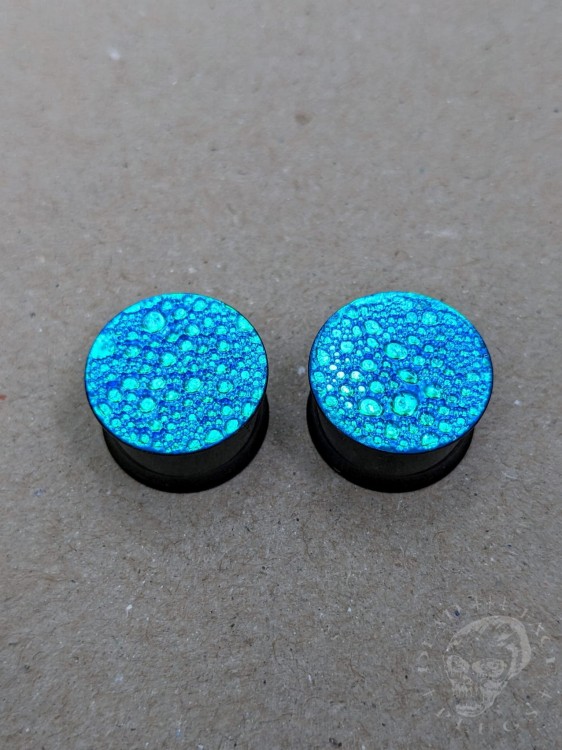 Unique black steel ear plugs with colorful surface and textured finish