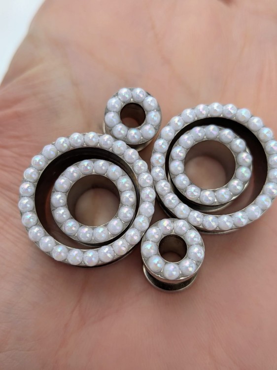 Silver stainless steel ear tunnels with opalescent pearl details