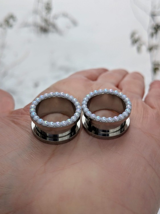 Silver stainless steel ear tunnels with opalescent pearl details
