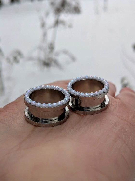 Elegant silver ear tunnels decorated with tiny white pearls