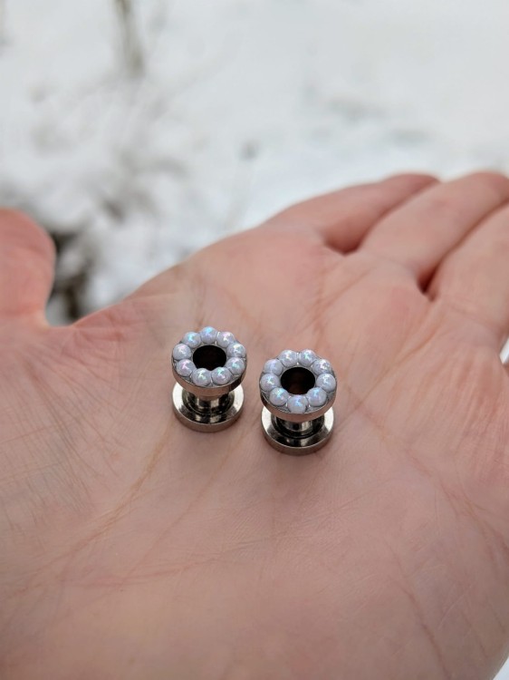 Elegant silver ear tunnels decorated with tiny white pearls