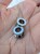 Silver stainless steel ear tunnels with blue opalescent embellishment