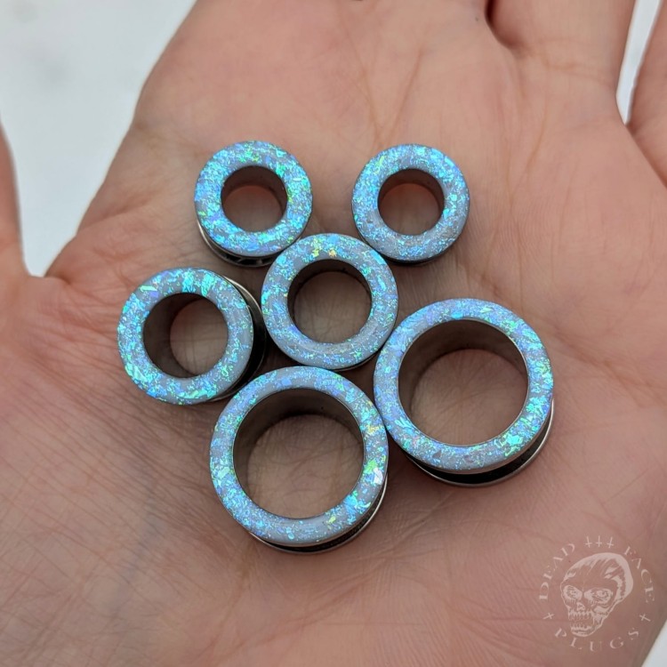 Ear tunnels with opalescent flakes in blue turquoise and green tones