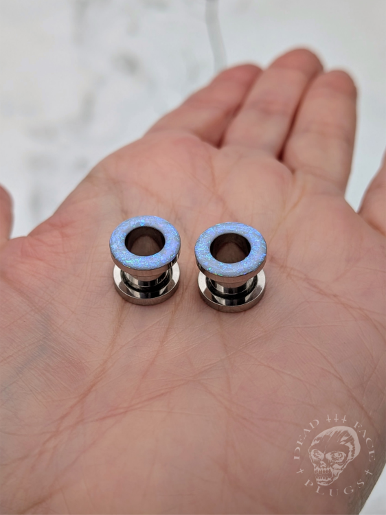 Ear tunnels with opalescent flakes in blue turquoise and green tones
