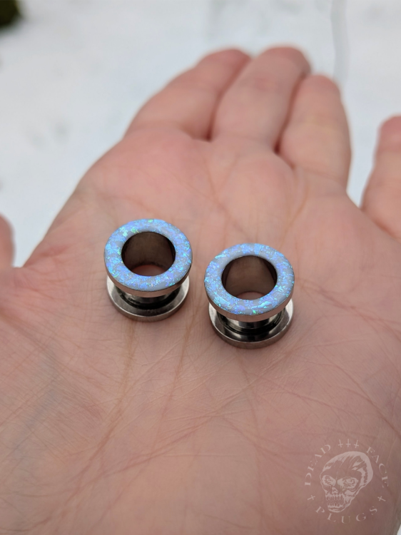 Ear tunnels with opalescent flakes in blue turquoise and green tones