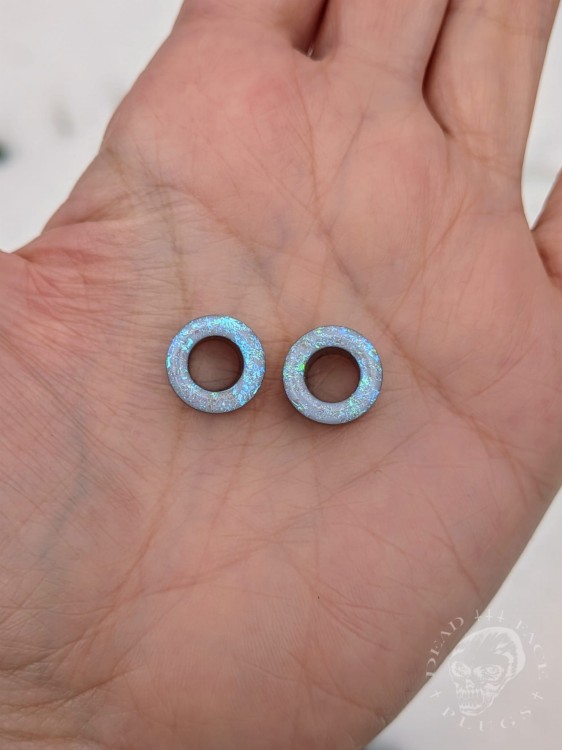 Ear tunnels with opalescent flakes in blue turquoise and green tones